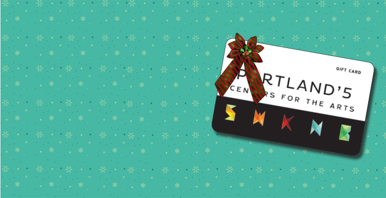 Image of Portland'5 gift card with a holiday bow on it, on a green background with white snowflakes