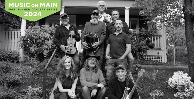 Black and white photo of Too Loose Cajun Band sitting on steps in front of house