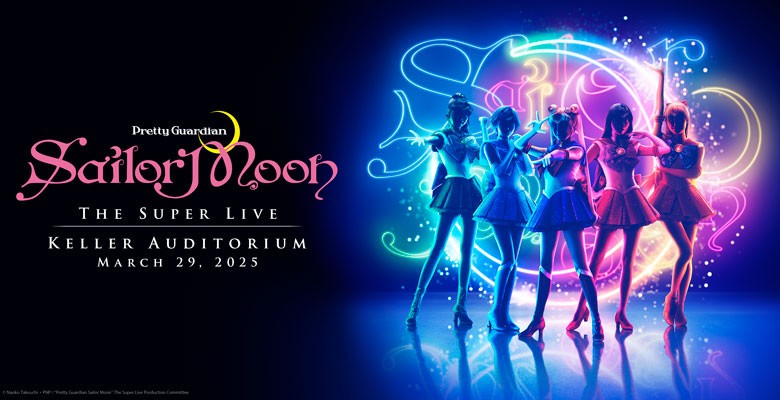 Sailor Moon and the Sailor Guardians pose on stage with colorful lighting