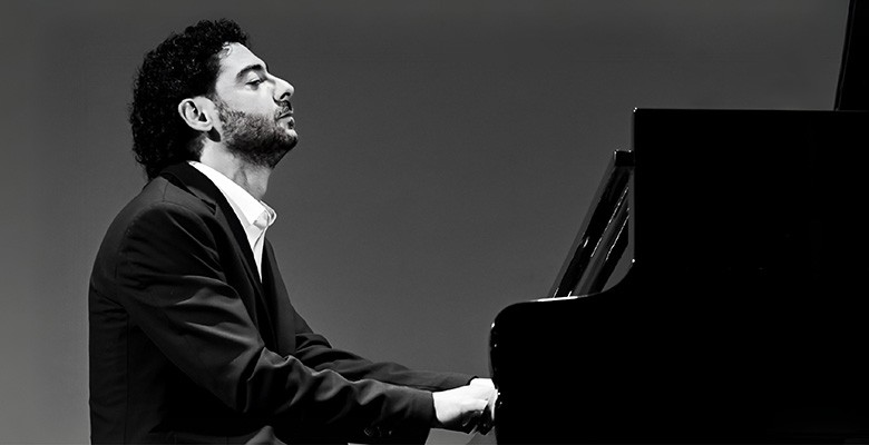 Photo of Artur Zakiyan sitting at and playing piano