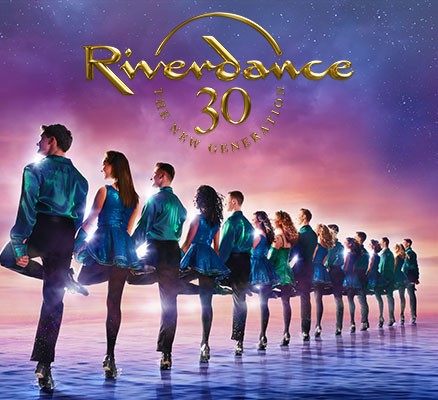 LIne of Irish dancers fading into the distance with Riverdance 30 logo above them.