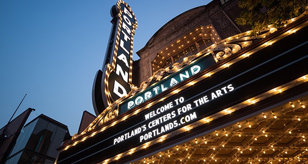 Cropped photo of the Schnitzer Concert Hall marquee and Portland sign lit up