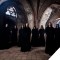 Monks of the Gregorian Pure Chants standing in a gothic church