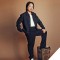 A photo of Jimmy O Yang standing with one foot raised on a box as he looks into the camera